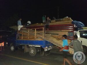 Moving the wood of an old traditional Toraja house to transport