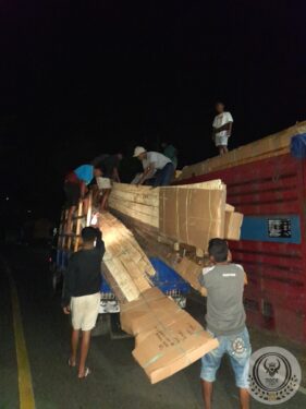 Moving the wood of an old traditional Toraja house to transport