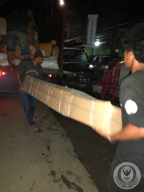 Moving the wood of an old traditional Toraja house to transport