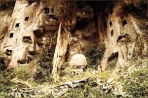 Tombs hollowed out of the rockface.