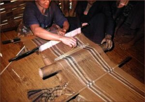 A woman weaving a cloth, Mamasa.